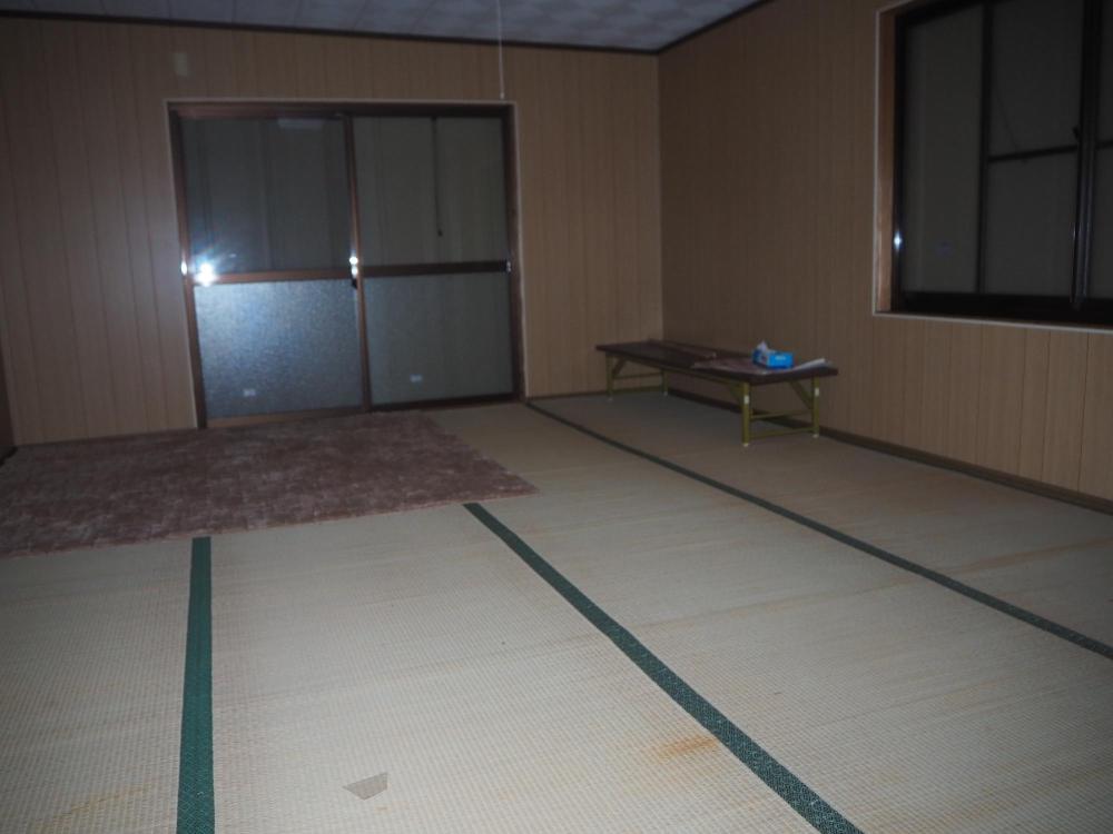 奥と壁沿いに窓が有る広い和室の写真